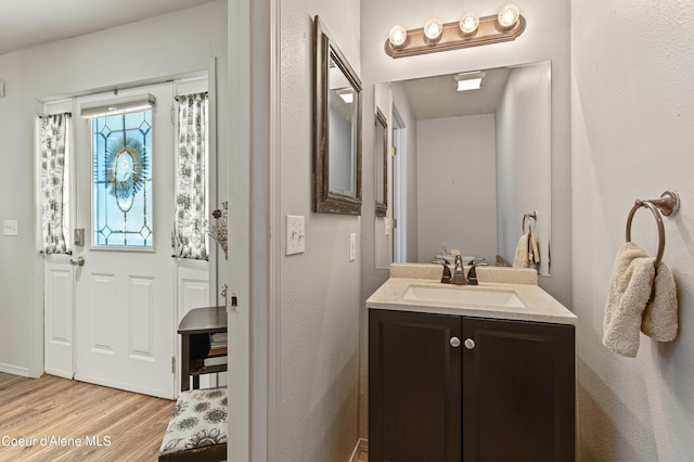 bathroom featuring hardwood / wood-style flooring and vanity