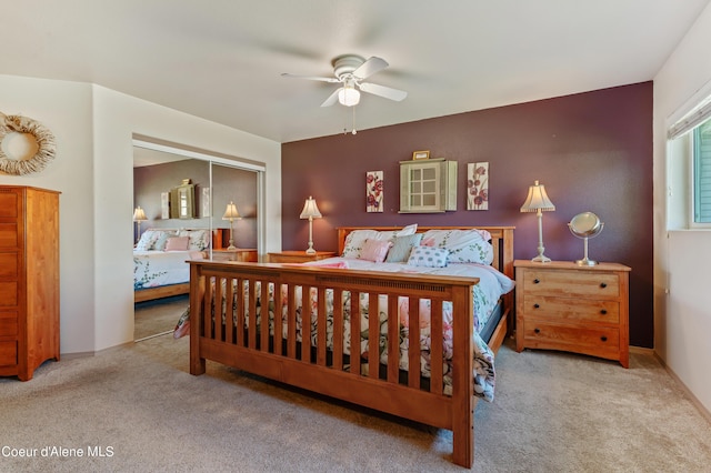 bedroom with light colored carpet, a closet, and ceiling fan