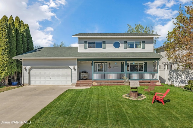 view of front of home featuring a garage, a front yard, and covered porch
