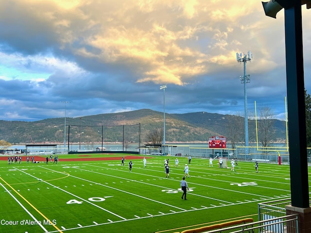 surrounding community with a water and mountain view