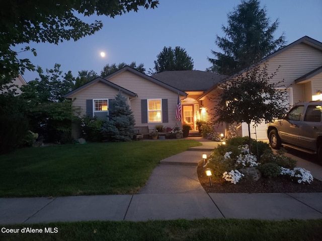 ranch-style home with a lawn