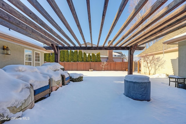 snow covered patio featuring a pergola