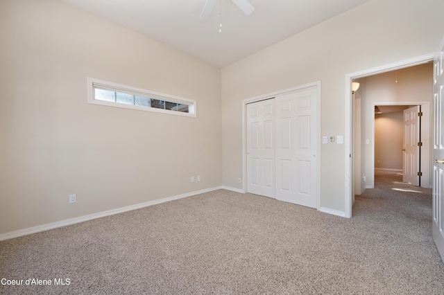 unfurnished bedroom with carpet flooring, ceiling fan, and a closet