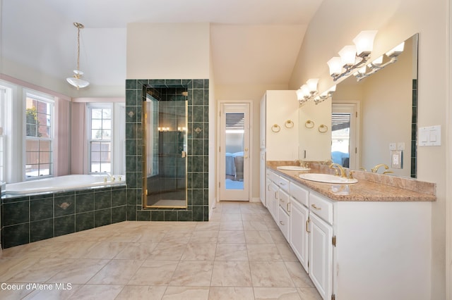 bathroom featuring lofted ceiling, vanity, a notable chandelier, a fireplace, and plus walk in shower