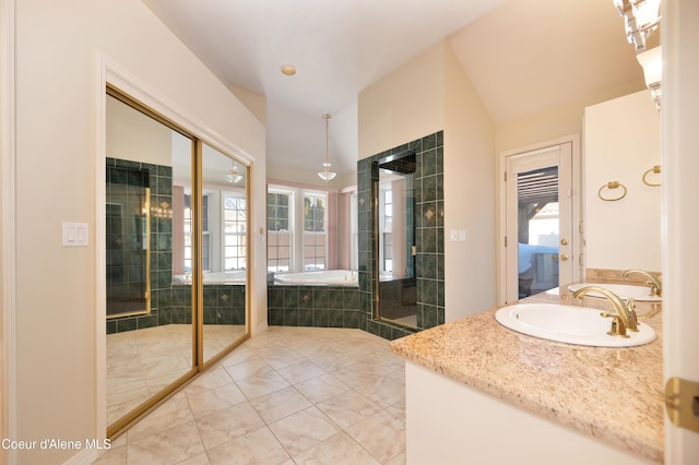 bathroom featuring independent shower and bath, vanity, and tile patterned floors