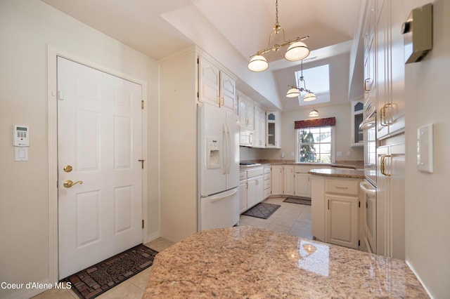 kitchen with white cabinetry, white appliances, light tile patterned flooring, and light stone counters