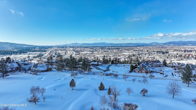 snowy aerial view featuring a mountain view