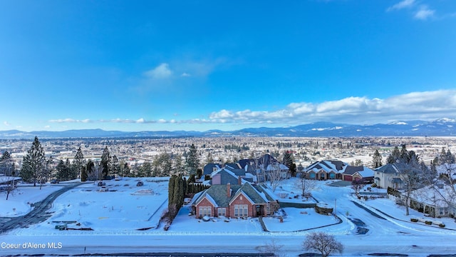 snowy aerial view with a mountain view