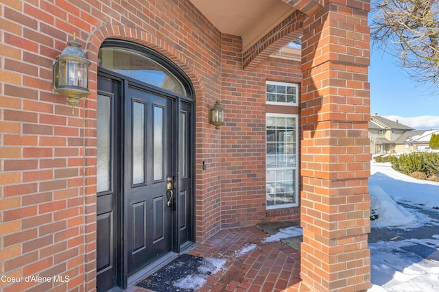 view of snow covered property entrance