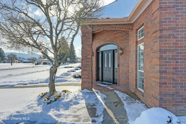 view of snow covered property entrance