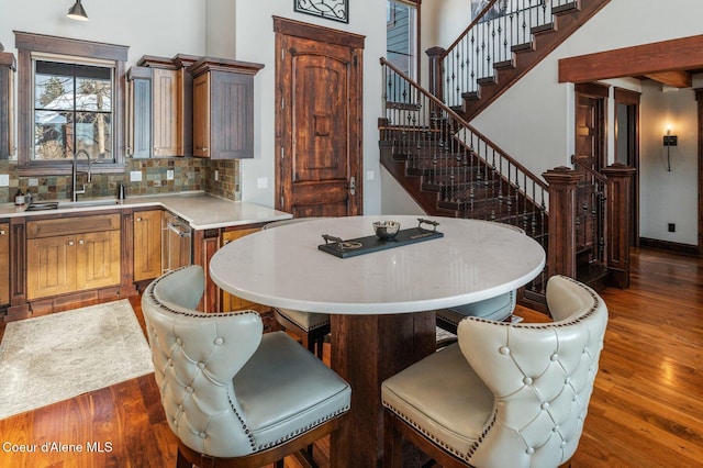 kitchen with a kitchen island, dark wood-type flooring, sink, and decorative backsplash