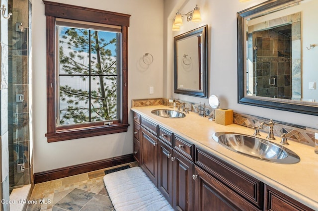 bathroom featuring vanity, a shower with shower door, and a wealth of natural light