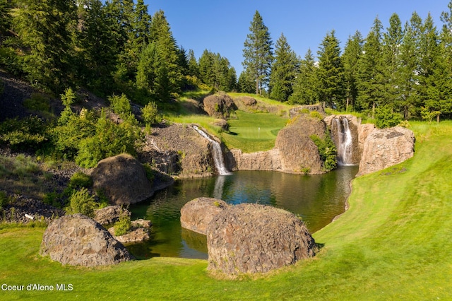 exterior space with a lawn and a water view