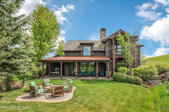 17036 S Citrine Dr, Coeur Dalene, ID 83814 - rear view of house featuring a chimney, a patio, a lawn, and an outdoor hangout area