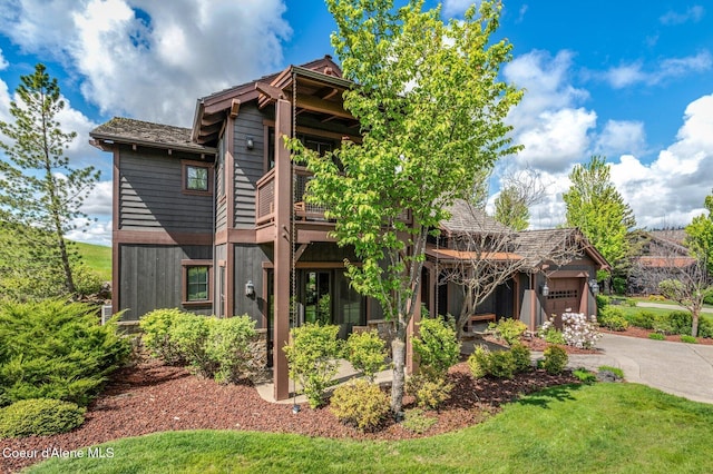 17036 S Citrine Dr, Coeur Dalene, ID 83814 - back of property with asphalt driveway and an attached garage