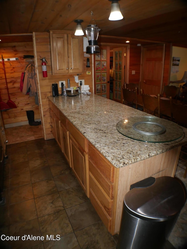 2820 Little Carpenter Creek Rd, Fernwood, ID 83830 - kitchen with wooden walls, a peninsula, and light stone counters