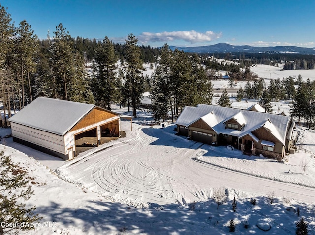 snowy aerial view with a mountain view