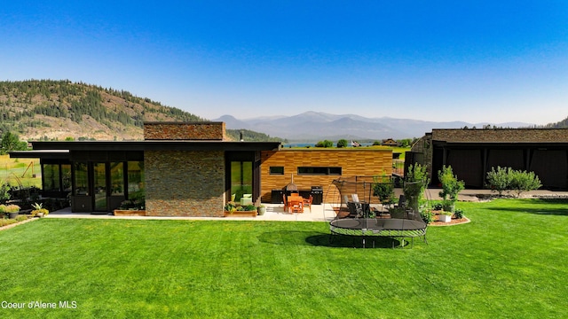 exterior space featuring a patio, a mountain view, and a trampoline