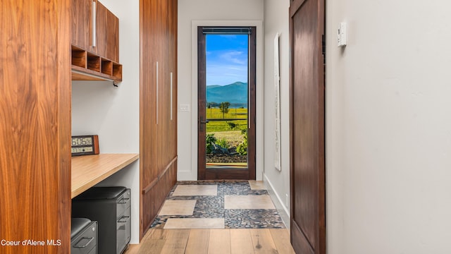 doorway to outside featuring a mountain view and light hardwood / wood-style flooring