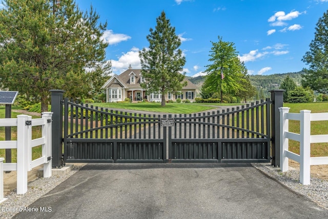 view of gate with a yard