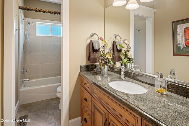 full bathroom featuring tile patterned floors, vanity, toilet, and tiled shower / bath combo