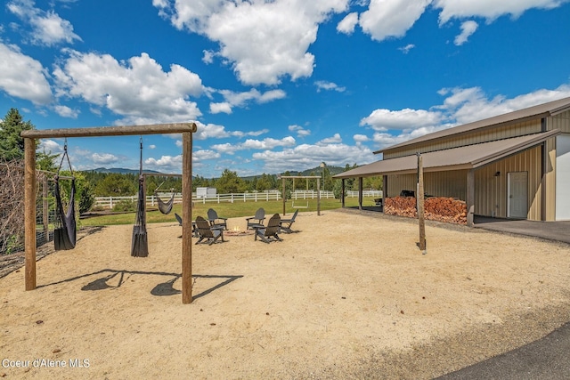 view of play area featuring an outdoor structure and a fire pit