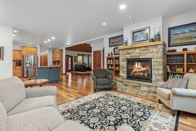 living room featuring a fireplace and light hardwood / wood-style flooring