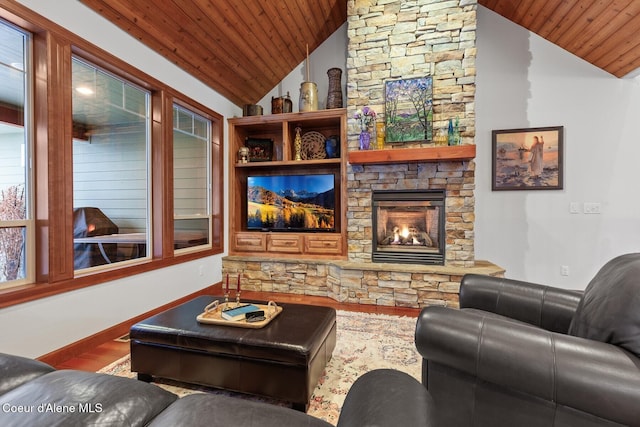 living room featuring vaulted ceiling, hardwood / wood-style floors, a fireplace, and wood ceiling