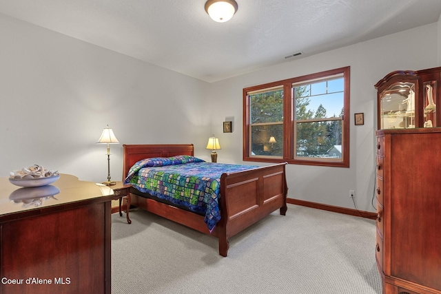 bedroom featuring light colored carpet