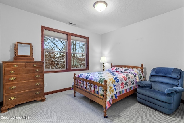 carpeted bedroom featuring a textured ceiling