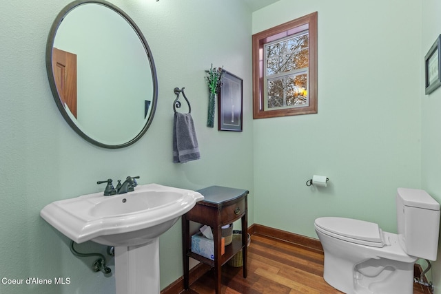 bathroom featuring hardwood / wood-style floors and toilet