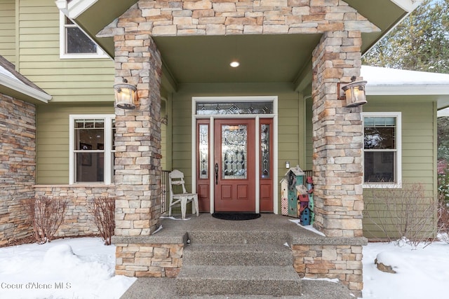 view of snow covered property entrance