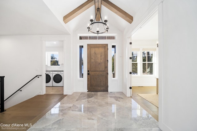 foyer entrance featuring independent washer and dryer, beam ceiling, high vaulted ceiling, and a notable chandelier