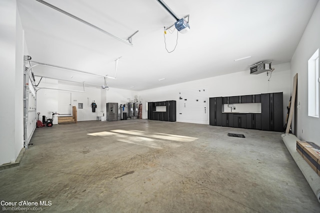 garage with a garage door opener and electric water heater