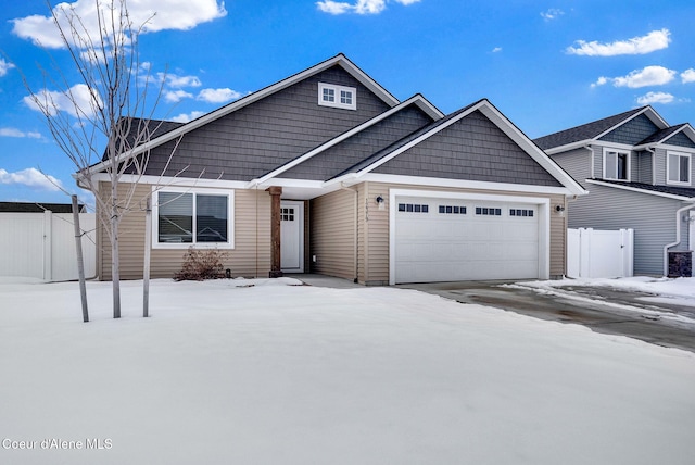 view of front of property featuring a garage, a gate, and fence