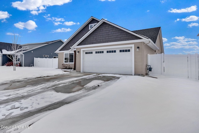 view of front of home with a garage and fence