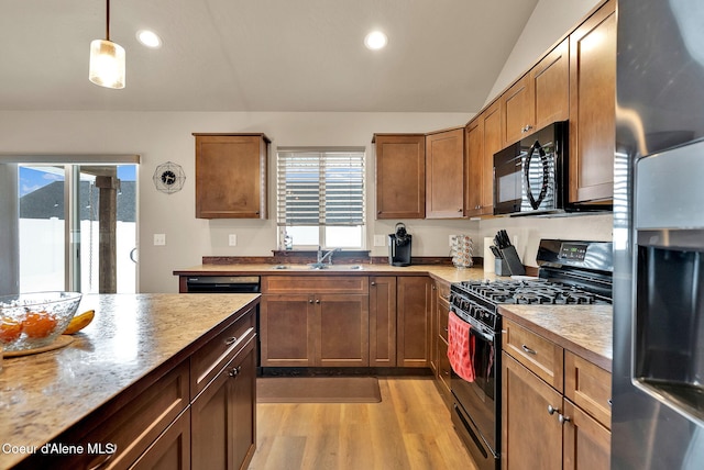 kitchen featuring black appliances, light wood-style floors, a sink, and recessed lighting