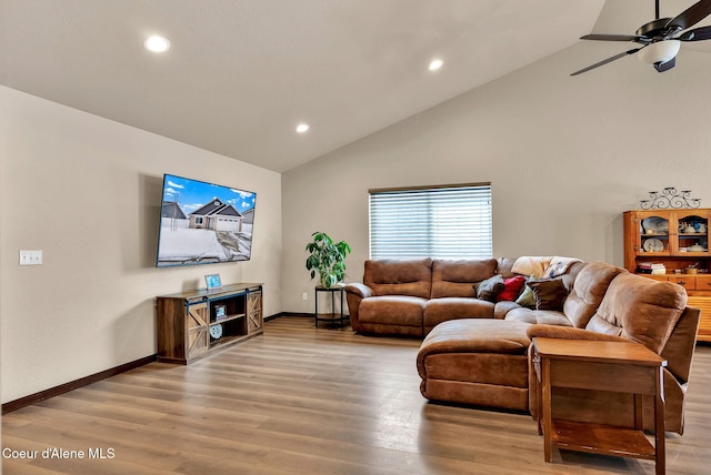 living area featuring high vaulted ceiling, recessed lighting, wood finished floors, a ceiling fan, and baseboards