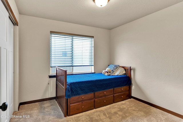 carpeted bedroom with baseboards