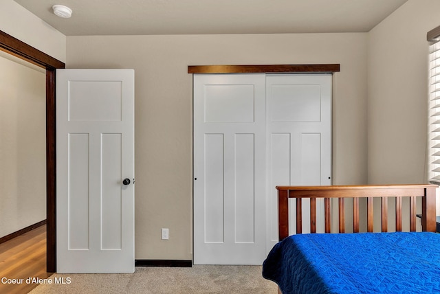 bedroom with a closet and baseboards