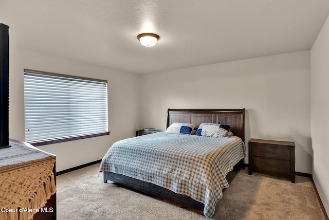 bedroom with baseboards and carpet flooring