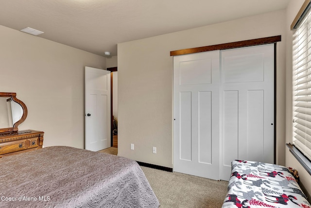 bedroom with light carpet and a closet