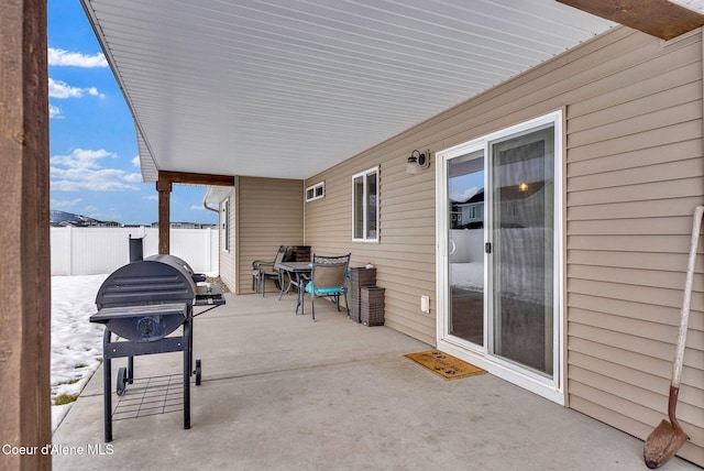 view of patio / terrace with area for grilling and fence