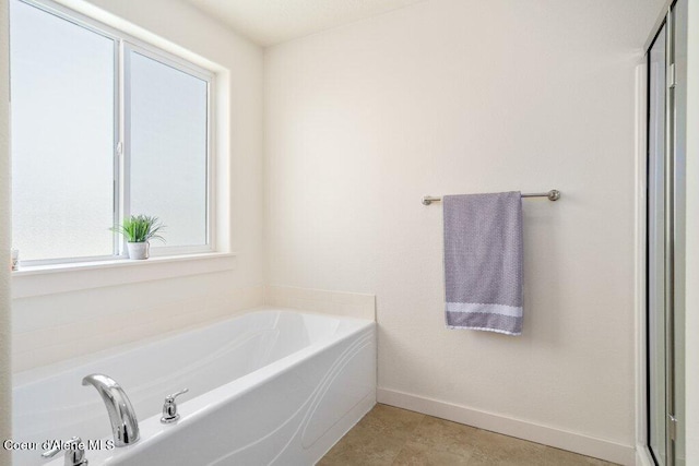 bathroom featuring tile patterned floors and a bathtub