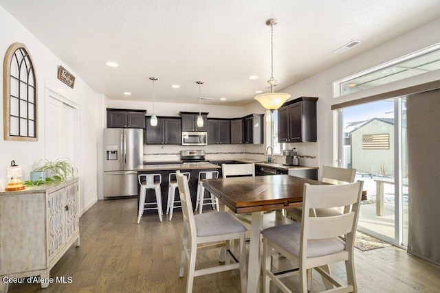 dining area featuring dark wood-type flooring