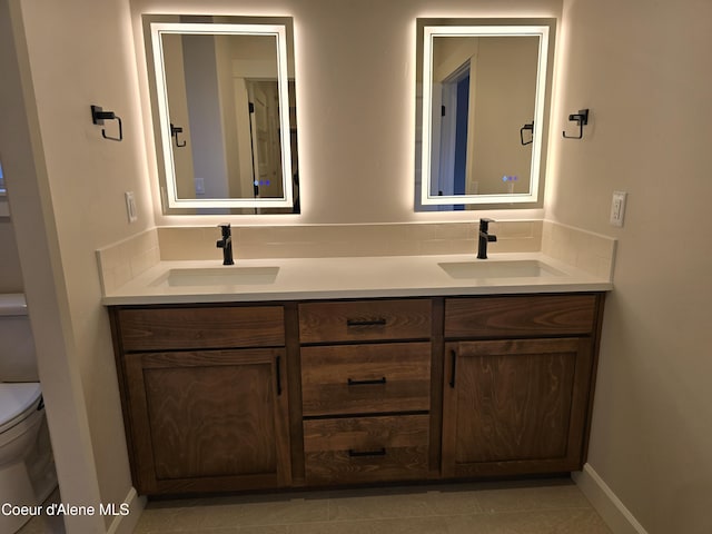 bathroom featuring vanity, backsplash, and toilet