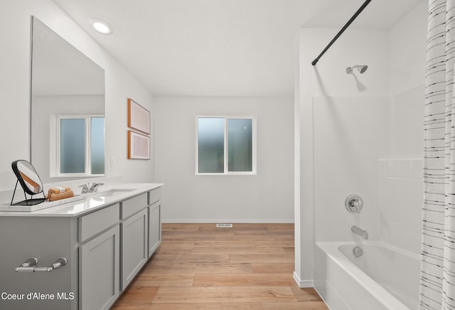 1497 N Luna St, Post Falls, ID 83854 - bathroom featuring hardwood / wood-style flooring, vanity, and shower / tub combo