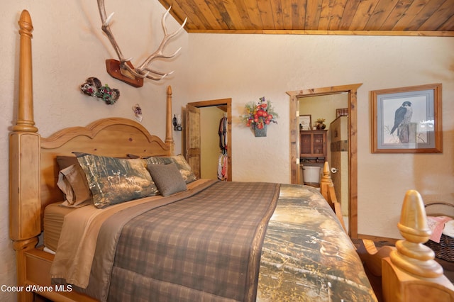 bedroom featuring ensuite bathroom and wooden ceiling