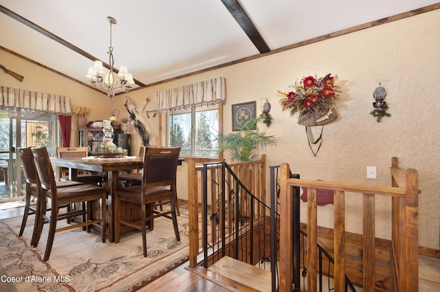 dining area featuring vaulted ceiling, wood-type flooring, a healthy amount of sunlight, and a chandelier