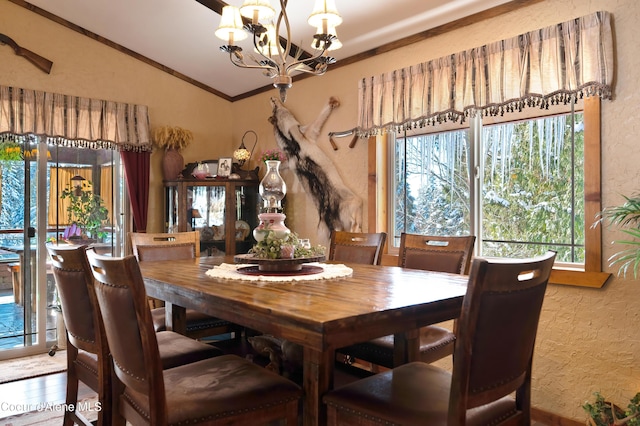 dining area with crown molding, an inviting chandelier, vaulted ceiling, and wood-type flooring